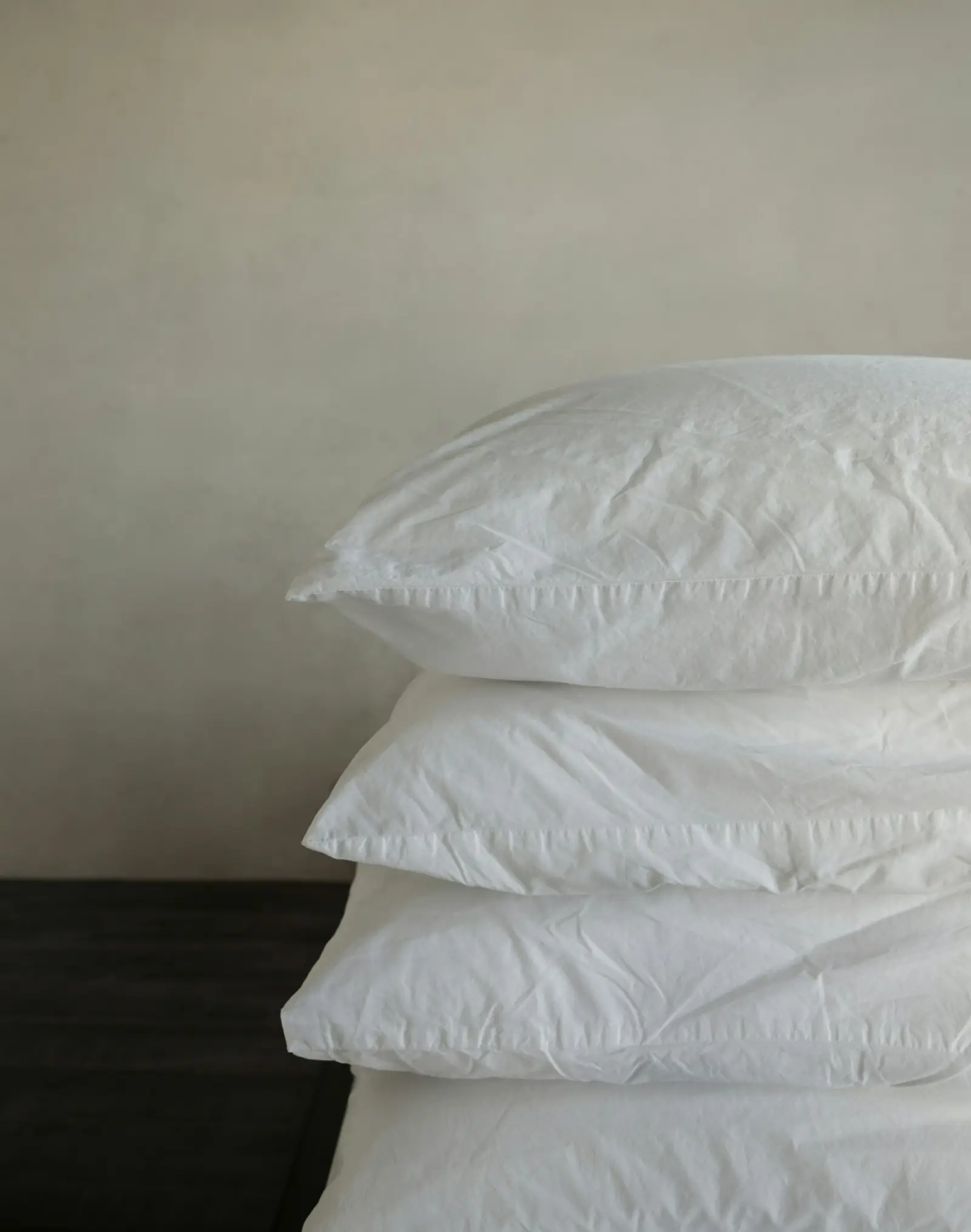 Stack of white pillows in plain pillow covers