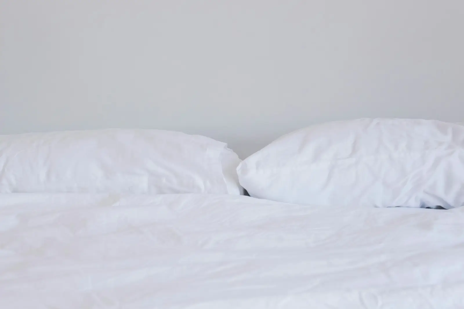 White pillows and duvet on a neatly made bed