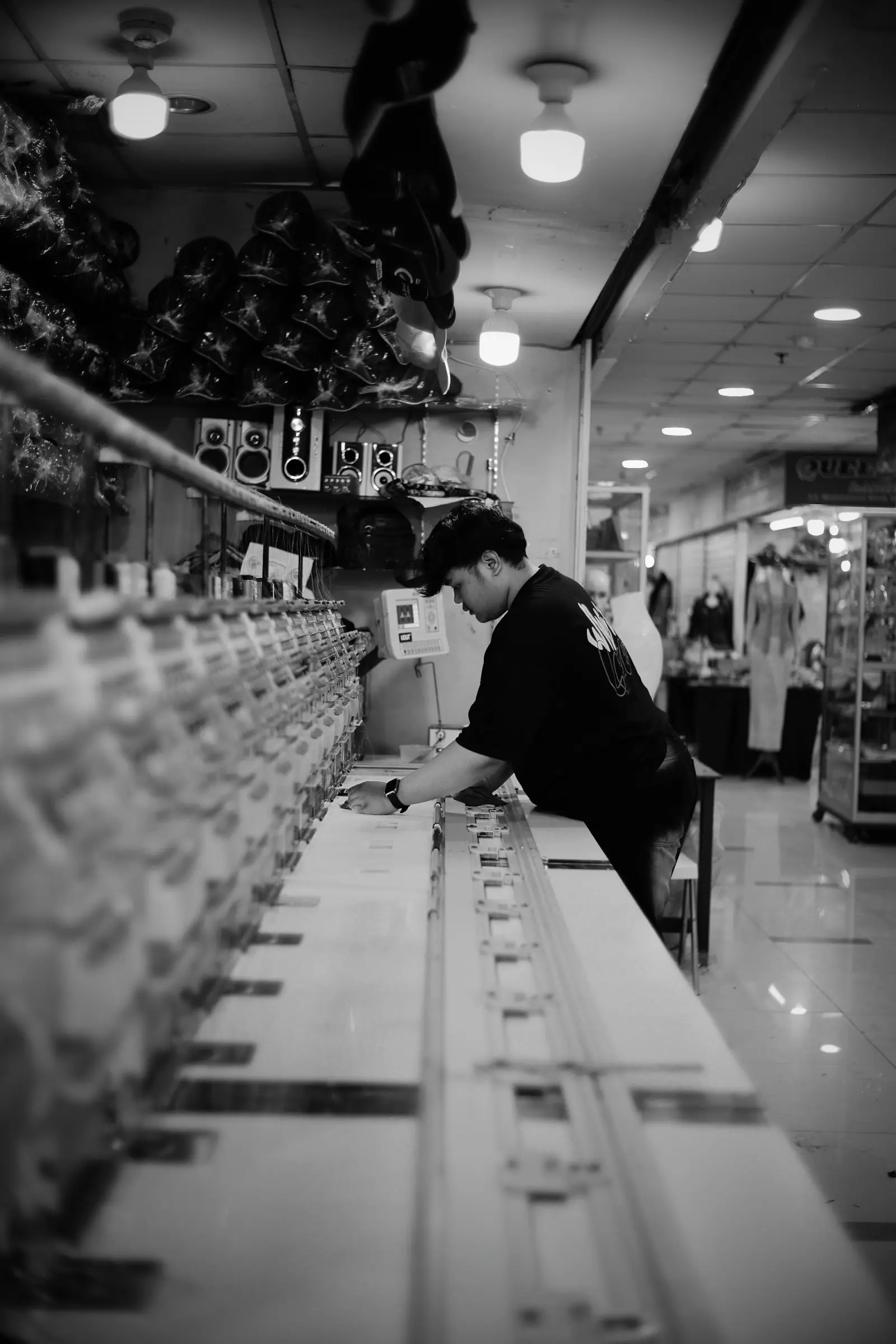 Operator checking a multi-head embroidery machine in a factory