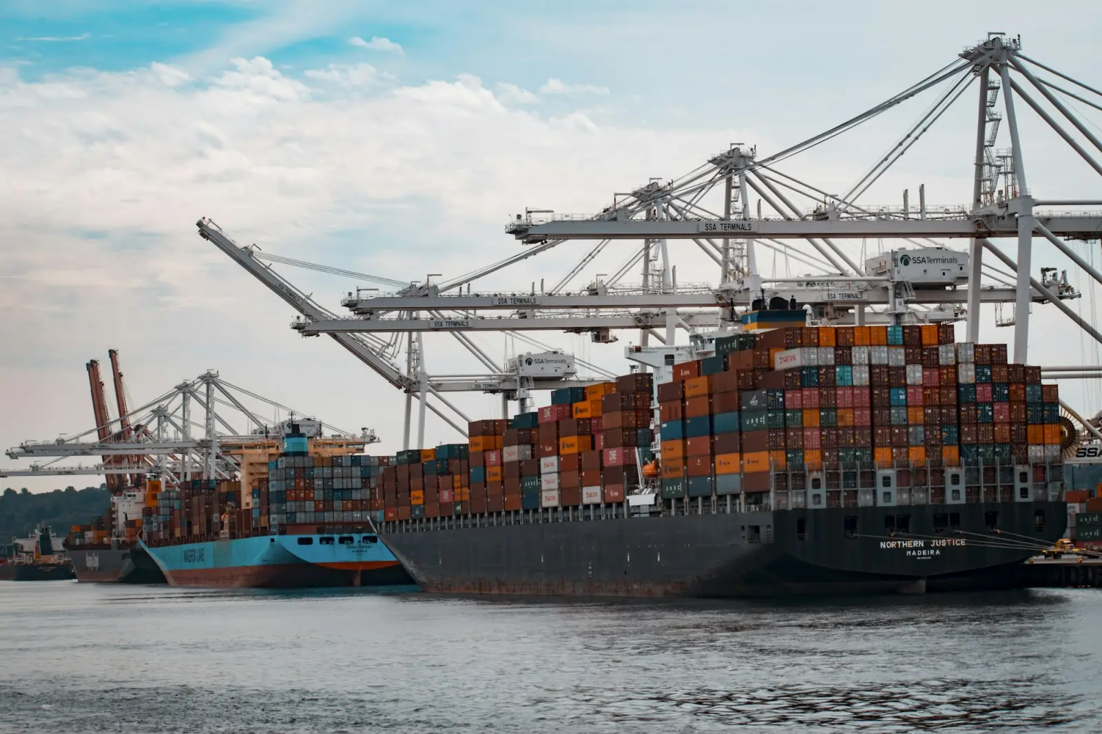 Container ships being loaded at a busy port