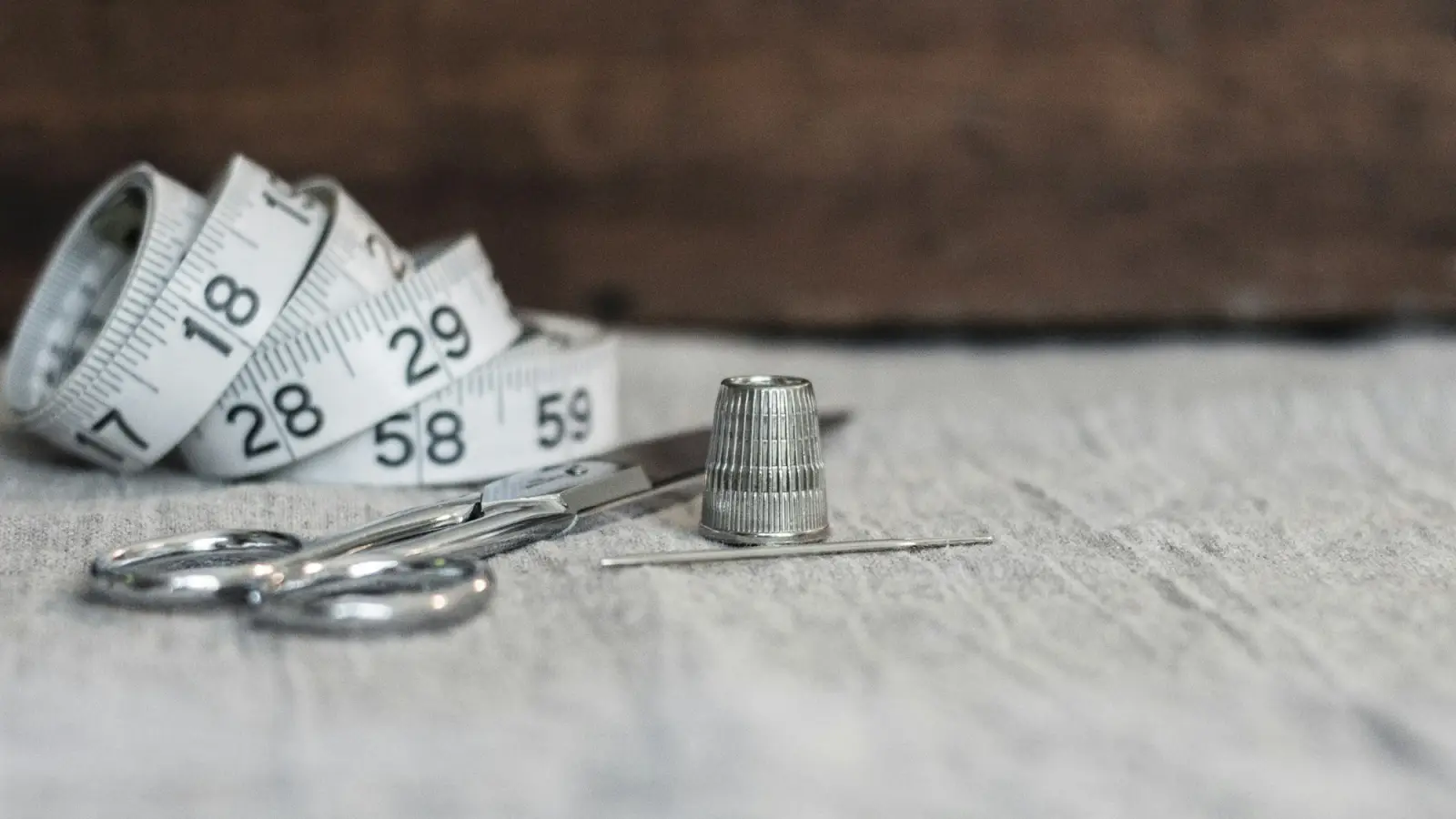 Measuring tape, scissors and thimble used to check garment measurements